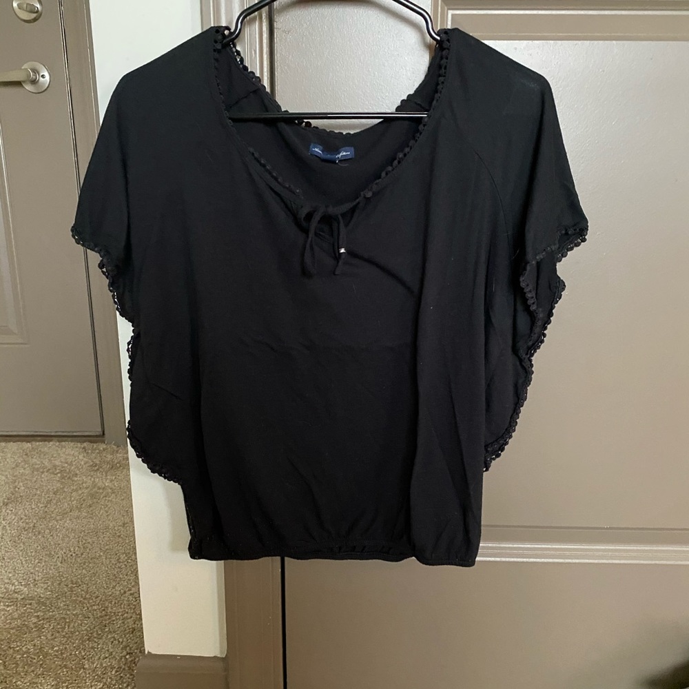 Black shirt with a tie in the front